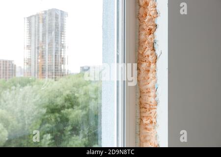 Process installation slopes of window. Using a moanting foam. Stock Photo