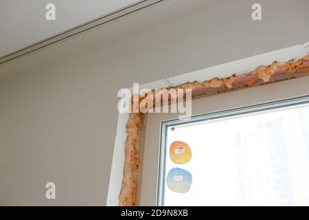 Process installation slopes of window. Using a moanting foam. Stock Photo