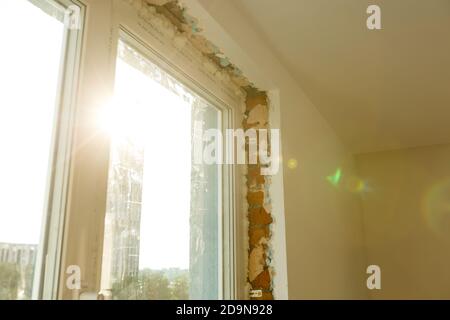 Process installation slopes of window. Using a moanting foam. Stock Photo