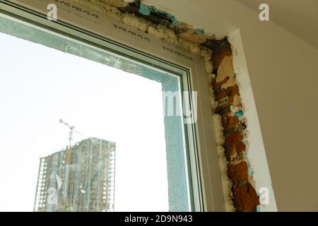 Process installation slopes of window. Using a moanting foam. Stock Photo