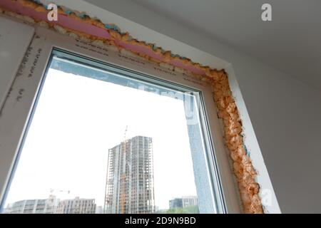 Process installation slopes of window. Using a moanting foam. Stock Photo