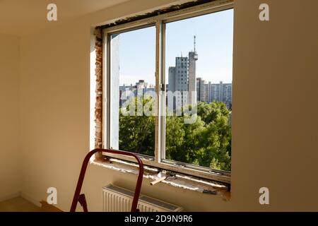 Process installation slopes of window. Using a moanting foam. Stock Photo