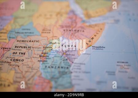 Kenya on a colorful and blurry map of Eastern Africa with its main routes in red Stock Photo