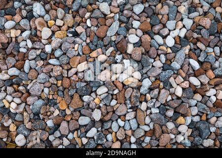 Different colored rocks and pebbles on a beach. Various colors and textures Stock Photo