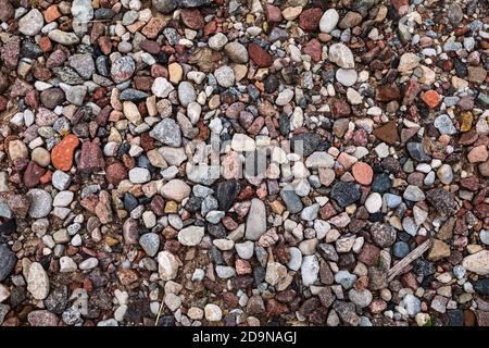 Different colored rocks and pebbles on a beach. Various colors and textures Stock Photo