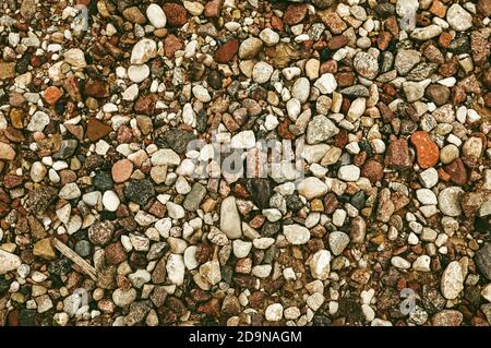 Different colored rocks and pebbles on a beach. Various colors and textures Stock Photo
