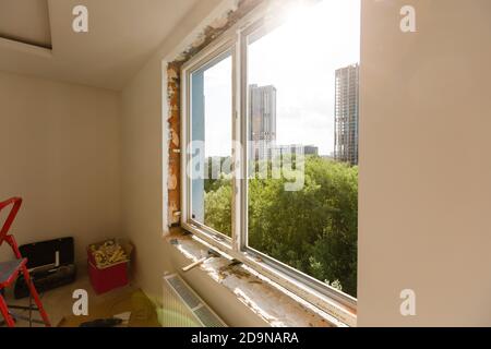 Process installation slopes of window. Using a moanting foam. Stock Photo