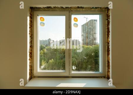 Process installation slopes of window. Using a moanting foam. Stock Photo
