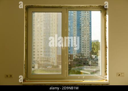 Process installation slopes of window. Using a moanting foam. Stock Photo