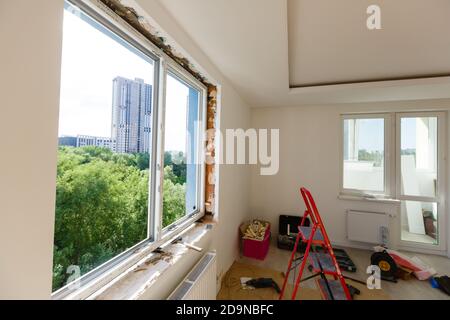 Process installation slopes of window. Using a moanting foam. Stock Photo