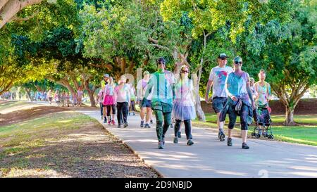 MACKAY, QUEENSLAND, AUSTRALIA - JUNE 2019: Unidentified couples covered in colored powder look happy in Color Frenzy Fun Run Stock Photo