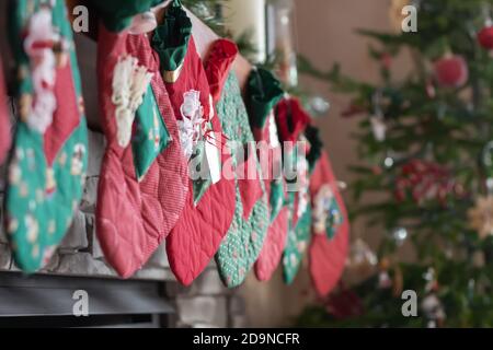 Christmas Stockings hanging on fireplace by tree Stock Photo