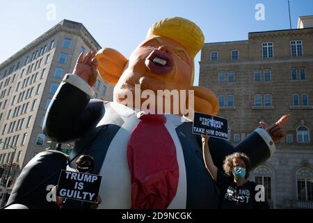Protesters hold signs in front of a giant inflatable blimp portraying President Trump as a rat, during a post-election demonstration organized by Shut Down DC and other activist groups to demand a complete and fair vote count in Washington, DC, on November 6, 2020, amid the coronavirus pandemic. With former Vice President Joe Biden holding a large but unconfirmed lead in the electoral college days after the election, protesters across the country gathered to demonstrate against President Donald Trump as confirmed COVID-19 cases surge nationwide. (Graeme Sloan/Sipa USA) Stock Photo