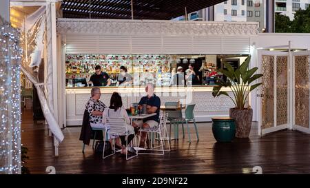 Mackay, Queensland, Australia - 12th July 2019: Guests dining at casual Lebanese restaurant in front of well stocked bar Stock Photo
