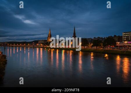 Inverness city landscape at night with the lights reflected in the river Ness, Scotland, United Kingdom Stock Photo