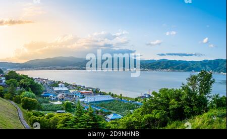 Suwa lake in Nagano, Japan in sunset time with city and mountain background. Landscape photo Stock Photo