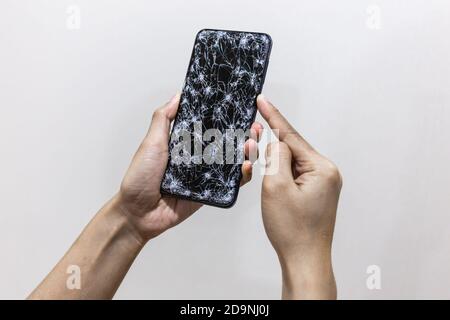 Woman Hand Holding Smartphone With Cracked Screen Stock Photo - Alamy
