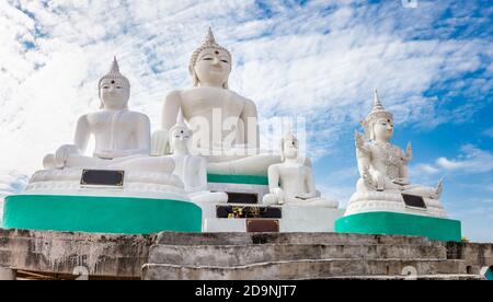 Many white Buddha on blue sky and cloud background Stock Photo