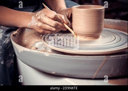 The process of making a clay jug on a potter's wheel. Close-up. Stock Photo