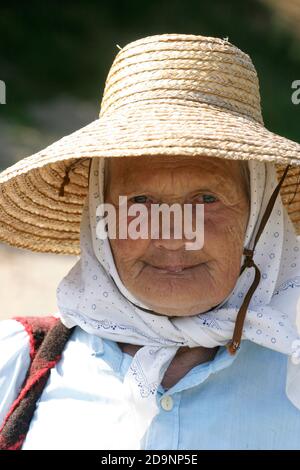 Portrait of an elderly woman wearing a straw hat in Transylvania, Romania Stock Photo