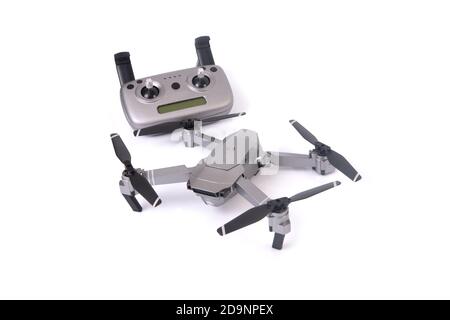 Small drone with remote control on white background. Stock Photo