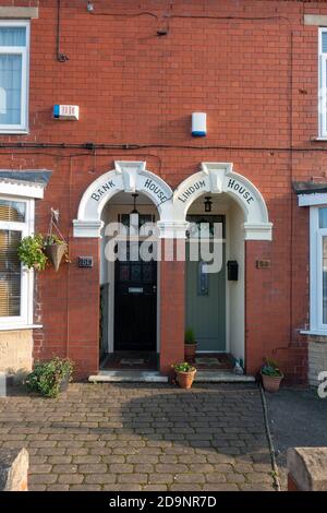 2 front doors side by side with arch top porch Stock Photo