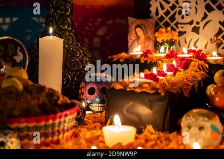 Colorful skull on colorful traditional Day of the Dead "ofrenda" Stock Photo