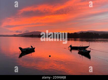 colorful sunset over the Minho river on the border between countries Stock Photo