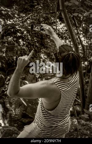 Boy takes a selfie in the woods, image in black and white Stock Photo