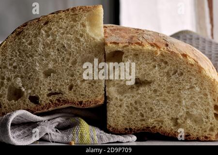Closeup of freshly baked bread in rustic style/ Fresh round bread with a beautiful crust lies on a wooden board Stock Photo