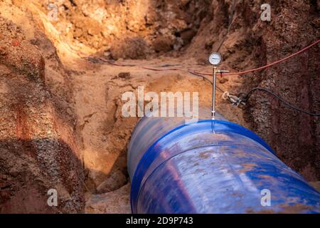 Pressure gauge meter installed on Large water pipe patch in the construction site Stock Photo