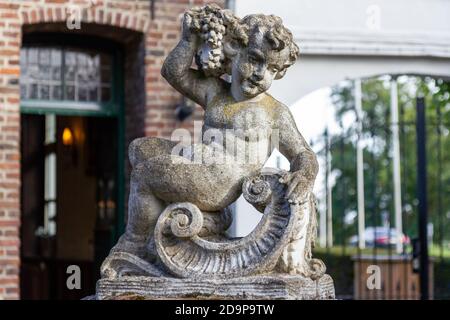 Stone statue of a boy Stock Photo