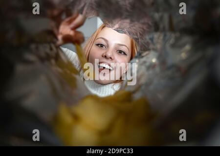 beautiful emotional girl teenager takes chips from the package and is happy. addiction to junk food in schoolchildren Stock Photo