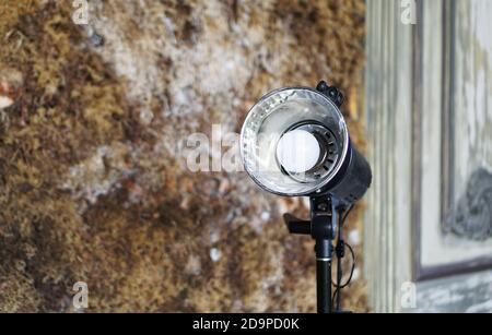 Studio flash against the background of an old wall with moss Stock Photo