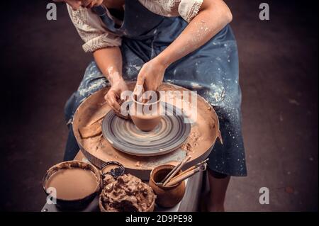 Processing clay ware and making dishes, process. Ceramics of handwork and clay ware on the potter's wheel. Stock Photo