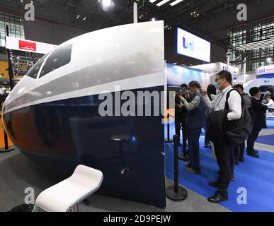 Shanghai, China. 6th Nov, 2020. People watch the flight simulator at the booth of Wright brothers at the Intelligent Industry and Information Technology exhibition area during the third China International Import Expo (CIIE) in Shanghai, east China, Nov. 6, 2020. Credit: Li Renzi/Xinhua/Alamy Live News Stock Photo