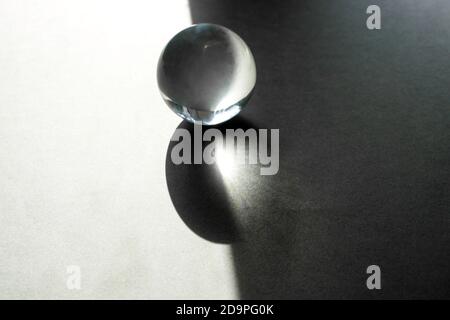 Glass transparent sphere with shadows, transparent ball on grey gradient background. Stock Photo