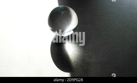 Glass transparent sphere with shadows, transparent ball on grey gradient background. Stock Photo
