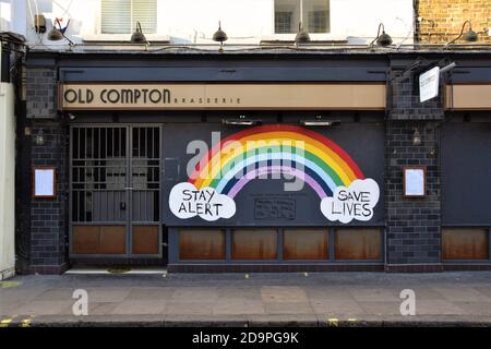 London, UK. 06th Nov, 2020. Daytime view of a Stay Alert, Save Lives rainbow sign outside a closed restaurant in Old Compton Street, Soho.Most shops, restaurants and businesses have closed as the second month-long nationwide Covid 19 lockdown begins in England. Credit: SOPA Images Limited/Alamy Live News Stock Photo