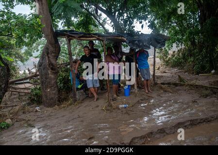 San Pedro Sula, Honduras. 06th Nov, 2020. A group of people take shelter from the rain in San Pedro Sula.Three days after Hurricane Eta hit the Nicaraguan coast as a Category 4 storm, the aftermath of flooding and mudslides has displaced over 350,000 Hondurans. The death toll in Central America is over 100 and expected to rise because of many missing people Credit: SOPA Images Limited/Alamy Live News Stock Photo