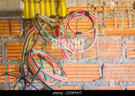 different colored cables for power outlet installation in construction site. Stock Photo