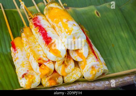 omelette roll stick on banana leaf in thai market, with copyspace on the right Stock Photo