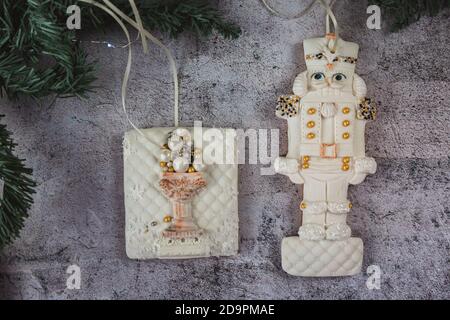 Hand painted Christmas gingerbread nutcracker on a beautiful grey background. Card concept. Top view. Flat lay. Copy space. Stock Photo