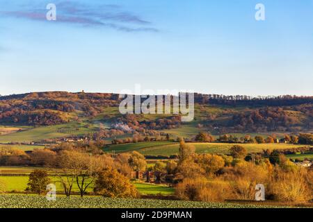 A late afternoon autumn view across fields to Bredon hill tower and Eckington bridge over the Avon river, Worcestershire, England Stock Photo