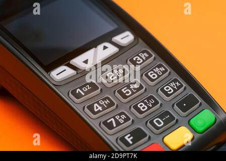 Close-up of a credit card machine. Contactless and cashless acceptance of payments by bank card or phone. Terminal for paying for purchases. Customer Stock Photo