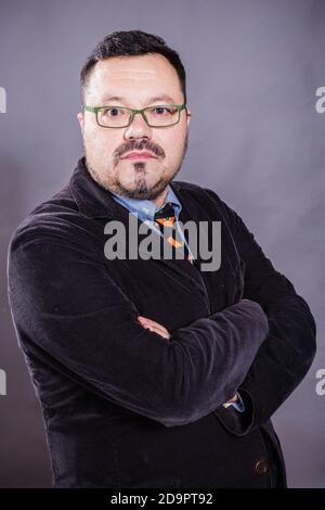 Solid cheerful man in spectacles emotional studio portrait Stock Photo