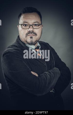 Solid cheerful man in spectacles emotional studio portrait Stock Photo