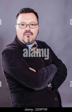 Solid cheerful man in spectacles emotional studio portrait Stock Photo