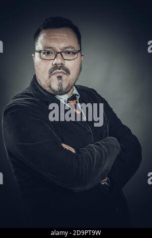 Solid cheerful man in spectacles emotional studio portrait Stock Photo