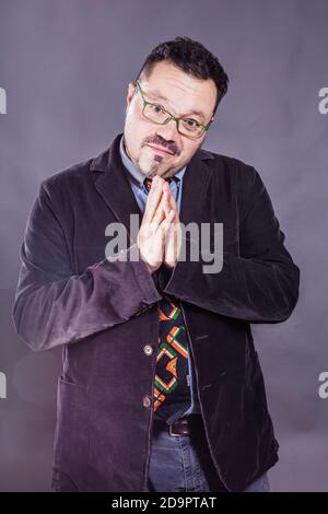 Solid cheerful man in spectacles emotional studio portrait Stock Photo